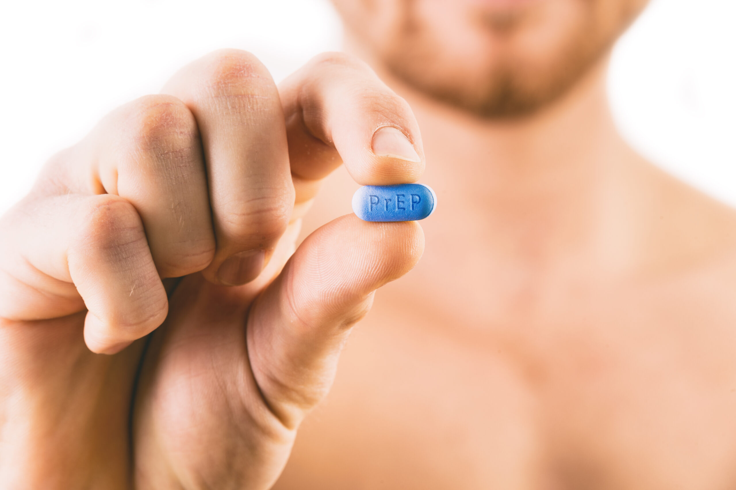 Man holding a PrEP (Pre-Exposure Prophylaxis) Pill